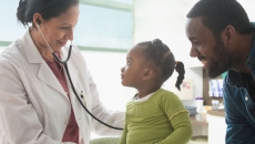 A parent with a toddler at a doctor's appointment A parent with a toddler at a doctor's appointment