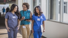 A doctor and nurses walking together in a hospital. A doctor and nurses walking together in a hospital.
