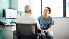 A provider talking to a patient while taking his blood pressure. A provider talking to a patient while taking his blood pressure.