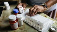 Hands and a pill organizer Hands and a pill organizer
