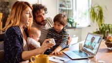 A family talking to a doctor on a laptop A family talking to a doctor on a laptop