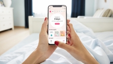 A close up of a woman using the Flo app