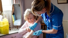 A nurse helping an older woman in her home A nurse helping an older woman in her home
