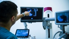 A doctor looking at a mammogram. A doctor looking at a mammogram.