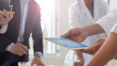 Business professionals and healthcare workers in a discussion.