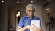 An older man using a tablet
