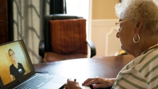 An older woman talks to a provider via telehealth An older woman talks to a provider via telehealth