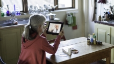 A woman talking to a provider through a video call on a tablet. A woman talking to a provider through a video call on a tablet.