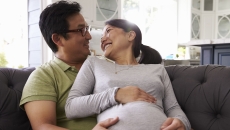 A pregnant woman and her partner A pregnant woman and her partner