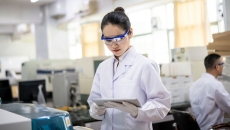 A researcher using her tablet in a lab A researcher using her tablet in a lab