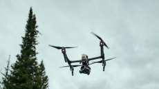 A drone flying over a forest area A drone flying over a forest area
