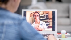 A patient talking to a provider via telehealth A patient talking to a provider via telehealth