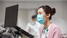 Healthcare professional looking at a computer