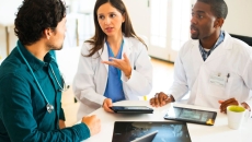 People sitting together looking at devices