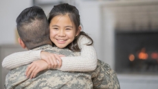 Veteran and a child hugging