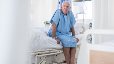 Patient in a hospital sitting on their bed