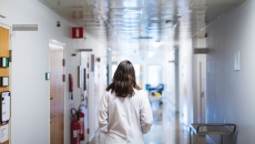Healthcare worker walking down the hallway in a hospital