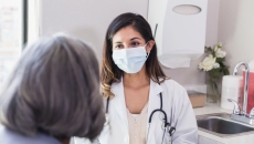 A doctor consulting with an elderly patient