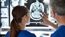 Two radiologists analysing a brain scan