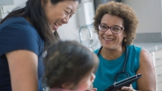 A mother and her child in a consultation with a doctor.