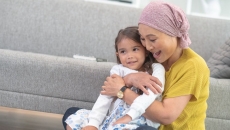 A woman holding a child while playing