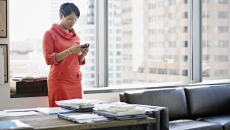 A person using a smartphone at a desk A person using a smartphone at a desk