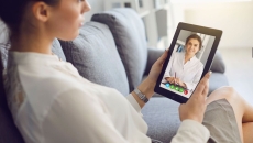 A woman talking to a provider on a tablet A woman talking to a provider on a tablet