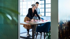 Two colleagues planning and brainstorming, using post its to organize ideas and plan Two colleagues planning and brainstorming, using post its to organize ideas and plan