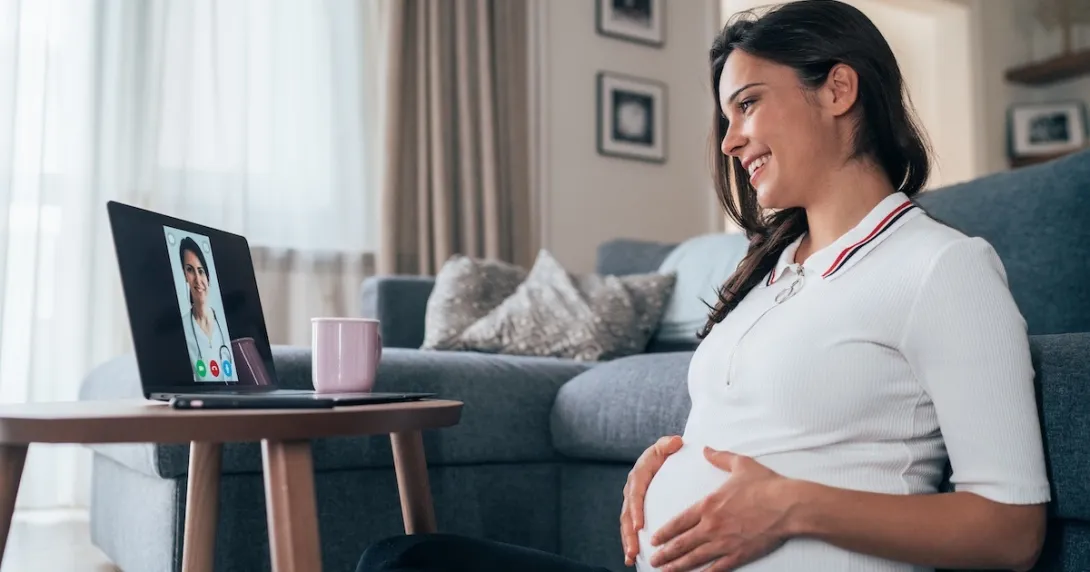 Pregnant women consulting with a healthcare professional via laptop computer Pregnant women consulting with a healthcare professional via laptop computer