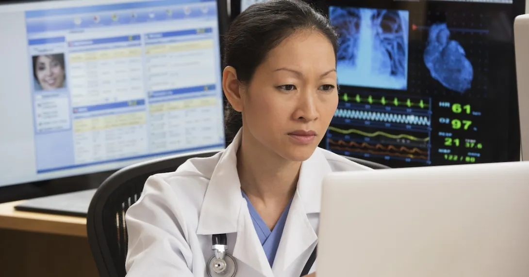 Healthcare technician reviewing MRI data Healthcare technician reviewing MRI data