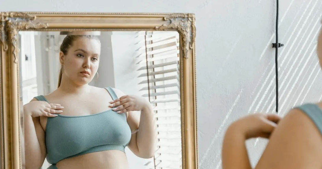 A person looking at their reflection in a mirror A person looking at their reflection in a mirror