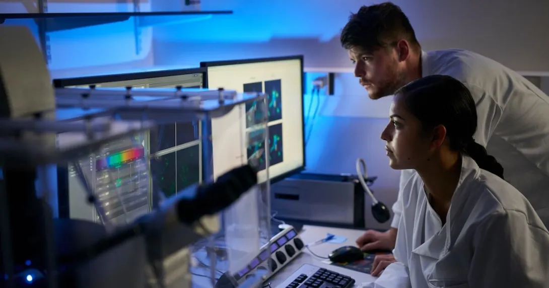 Two healthcare provider in a dark room looking at a screen Two healthcare provider in a dark room looking at a screen