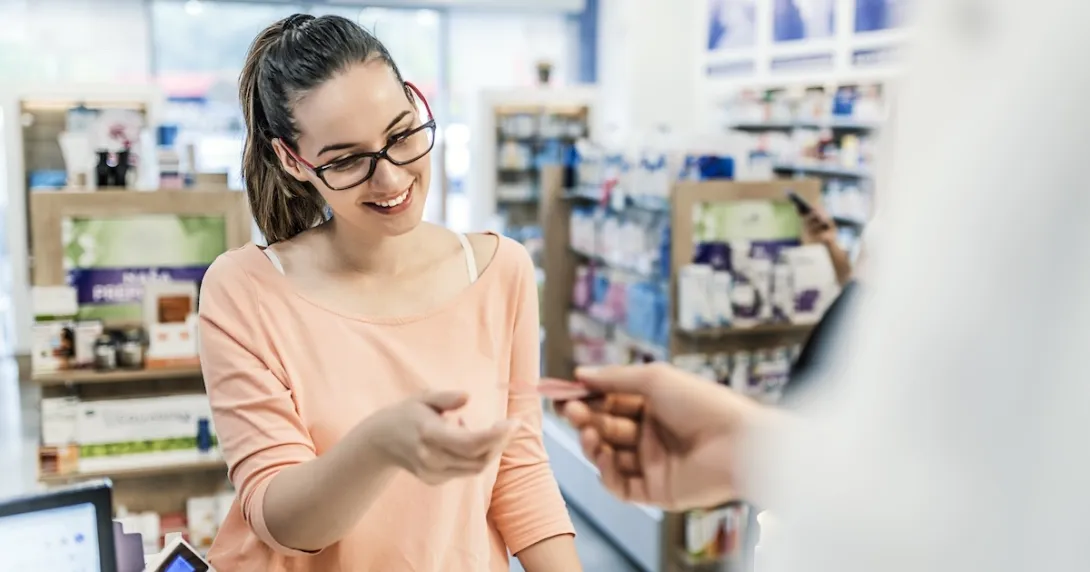 Patient picking up a prescription at a retail pharmacy Patient picking up a prescription at a retail pharmacy