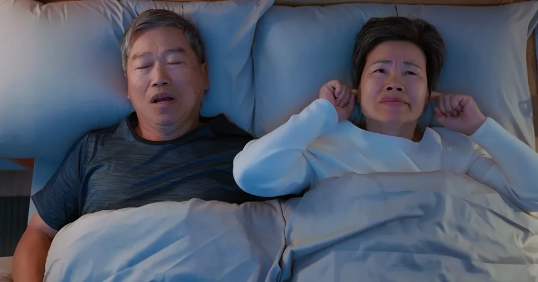 Man with sleep apnea in bed with his wife Man with sleep apnea in bed with his wife