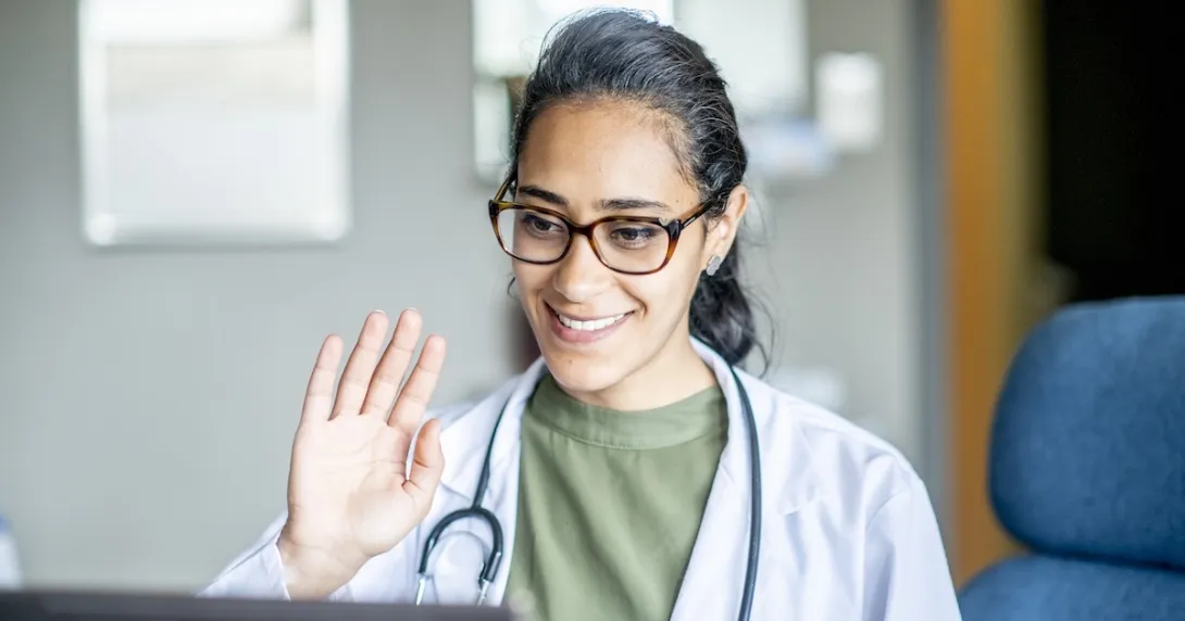 Healthcare professional engaging remotely via a laptop computer Healthcare professional engaging remotely via a laptop computer
