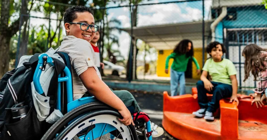 Student in a wheelchair on a playground Student in a wheelchair on a playground