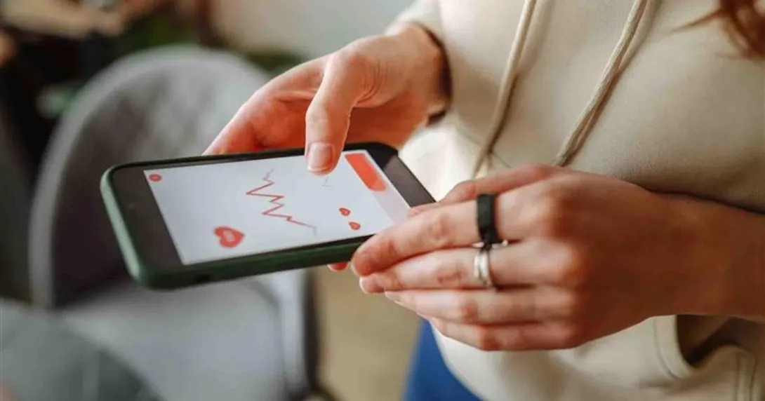 A person looking at data on a smart phone A person looking at data on a smart phone