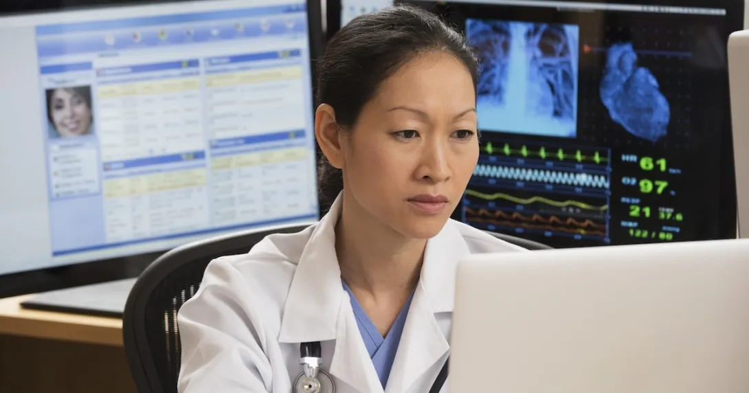 Healthcare professional reviewing patient data on a PC Healthcare professional reviewing patient data on a PC