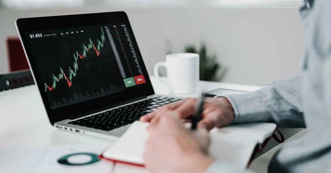 Young businessman using laptop for analyzing data stock market Young businessman using laptop for analyzing data stock market