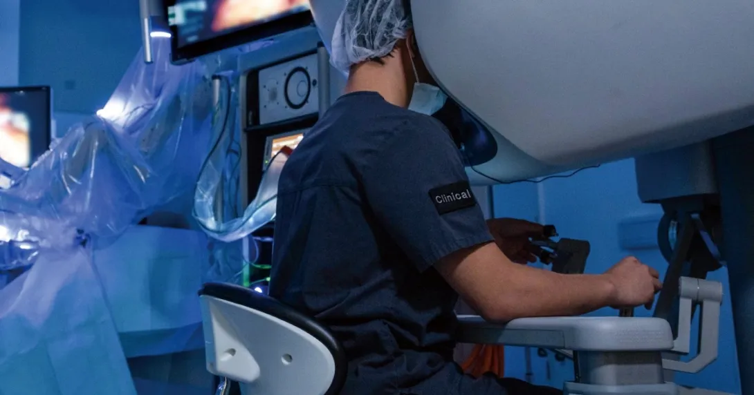 A surgeon operating using robotic technology A surgeon operating using robotic technology