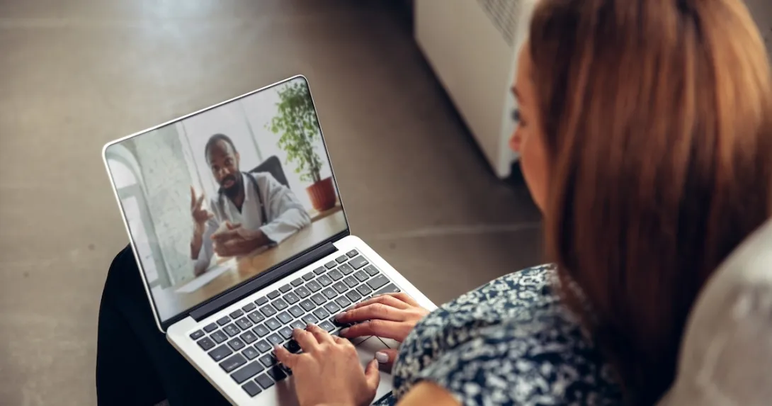 Patient interacting with healthcare professional via laptop Patient interacting with healthcare professional via laptop