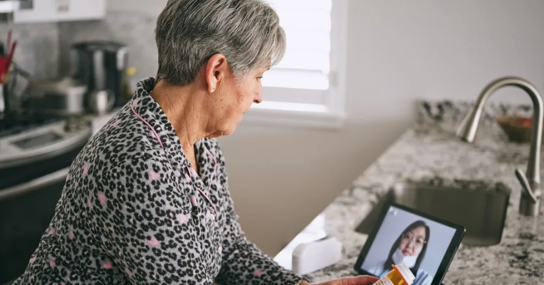 Patient interacting with healthcare professional via tablet Patient interacting with healthcare professional via tablet