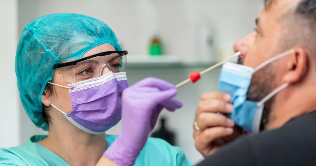 A provider conducting a COVID-19 test. A provider conducting a COVID-19 test.