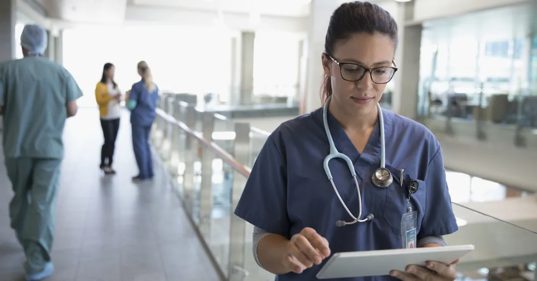 Healthcare professional looking at a tablet Healthcare professional looking at a tablet