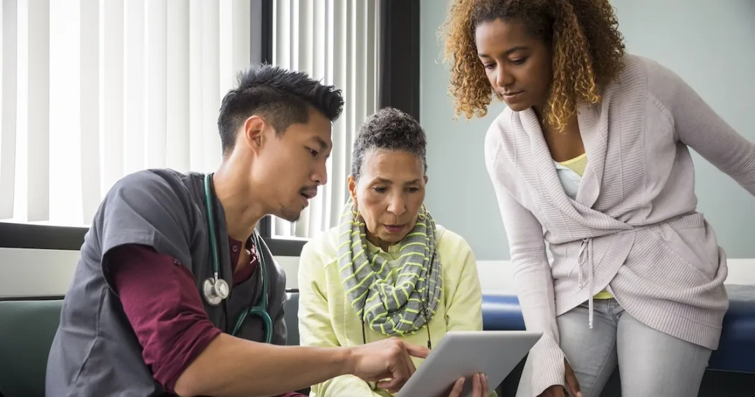Healthcare worker consulting with a patient and family member Healthcare worker consulting with a patient and family member
