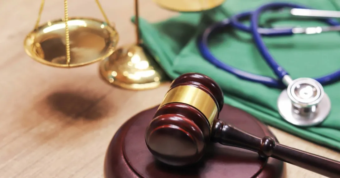 A gavel next to a stethoscope A gavel next to a stethoscope
