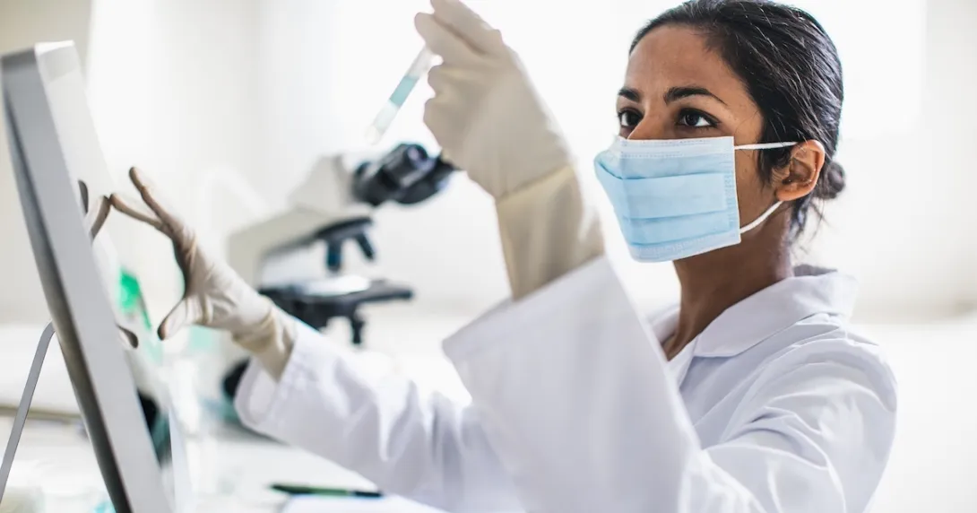 Scientist analyzing contents of test tube Scientist analyzing contents of test tube