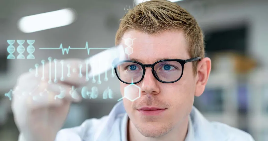 Scientist in a laboratory holding a microscope slide with digitization display in a laboratory