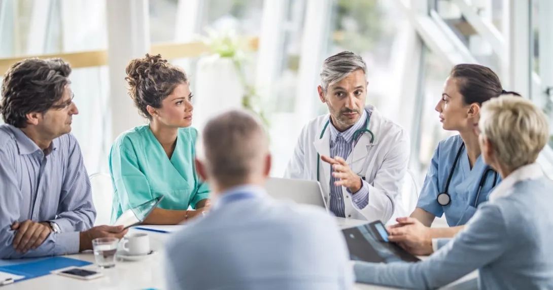 medical providers and business people sit around table medical providers and business people sit around table
