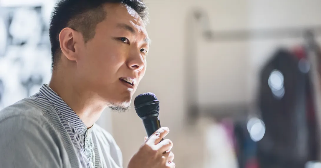 Person speaking in a microphone Person speaking in a microphone